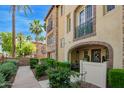 Townhouse with stone accents, arched entryway, and wrought-iron balcony at 4419 N 24Th Way, Phoenix, AZ 85016