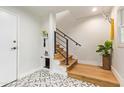 Modern staircase with wood treads, black metal railings, decorative tile landing, and a stylish pet space below at 4419 N 24Th Way, Phoenix, AZ 85016