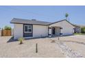 This single-story home features a charming entrance and low-maintenance desert landscaping at 4509 E La Puente Ave, Phoenix, AZ 85044
