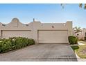 Southwestern home featuring attached garages, desert landscaping, neutral paint, and bronco artistic desert detail at 5445 E Mckellips Rd # 23, Mesa, AZ 85215