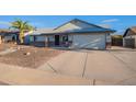 Inviting single-story home with a well-maintained front yard and a spacious driveway leading to a two-car garage at 6311 E Ivy St, Mesa, AZ 85205
