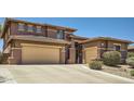 Spacious home boasts a two-car garage and inviting curb appeal with an extra parking space at 6350 S Four Peaks Pl, Chandler, AZ 85249