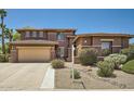 Charming two-story home featuring a two-car garage and a well-manicured front yard at 6350 S Four Peaks Pl, Chandler, AZ 85249