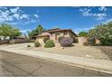 An inviting home with desert landscaping and a view of the side entry at 6350 S Four Peaks Pl, Chandler, AZ 85249