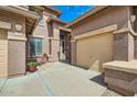 A tan home with a spacious driveway and a cozy seating area near the front entrance at 6350 S Four Peaks Pl, Chandler, AZ 85249