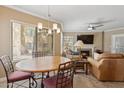 Cozy living room and dining area featuring large windows, wood furnishings, and fireplace at 7575 E Indian Bend Rd # 1137, Scottsdale, AZ 85250