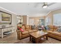 Spacious living room featuring tile floors, leather seating, and a large center table at 7575 E Indian Bend Rd # 1137, Scottsdale, AZ 85250