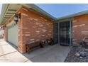 Inviting front entrance with a secure metal gate and a bench, leading to the front door at 7608 W Mescal St, Peoria, AZ 85345