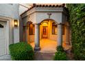 Grand entrance featuring stately columns, arched entryways, and a beautiful wooden door at 8429 E Del Camino Dr, Scottsdale, AZ 85258