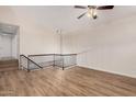 Living room with staircase and railing, vaulted ceiling, ceiling fan and chandelier at 917 N Blackbird Dr, Gilbert, AZ 85234