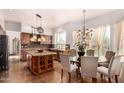 Well-lit kitchen with island, granite counters, stainless appliances, and a breakfast nook with large windows at 9203 E Topeka Dr, Scottsdale, AZ 85255