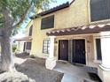 Inviting townhome exterior with well-maintained landscaping and entrances with security doors at 921 W University Dr # 1038, Mesa, AZ 85201