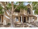 Charming two-story townhouse featuring a tile roof, covered entrance, and mature landscaping at 921 W University Dr # 1038, Mesa, AZ 85201