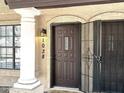 Inviting front door with security gate, decorative window, and exterior lighting at 921 W University Dr # 1038, Mesa, AZ 85201