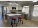 Modern kitchen with stainless steel appliances, center island, and updated cabinets at 9853 W Pontiac Dr, Peoria, AZ 85382