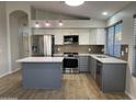 Updated kitchen featuring modern stainless steel appliances, stylish countertops, and gray and white cabinetry at 9853 W Pontiac Dr, Peoria, AZ 85382