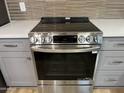 Close-up of a stainless steel range with sleek design and modern touch controls at 9853 W Pontiac Dr, Peoria, AZ 85382