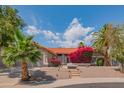 Beautiful single-story home featuring desert landscaping and a lovely red brick facade at 10580 E Bella Vista Dr, Scottsdale, AZ 85258
