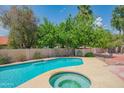 Inviting backyard pool and spa with a lush garden for relaxation and entertainment at 10580 E Bella Vista Dr, Scottsdale, AZ 85258