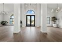 Bright foyer with hardwood floors, high ceilings, and large front doors at 10755 E Cholla Ln, Scottsdale, AZ 85259