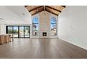 Spacious living room with vaulted wood ceilings and a stone fireplace at 10755 E Cholla Ln, Scottsdale, AZ 85259