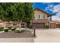 Charming two-story home featuring a stone facade, landscaped yard and inviting front entrance at 1121 W Mission Dr, Chandler, AZ 85224