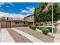 Well-maintained two-story home with stone accents, solar panels, landscaped front yard and long driveway at 1121 W Mission Dr, Chandler, AZ 85224