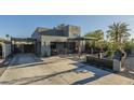 Contemporary home featuring a zero landscape front yard, covered patio, and driveway with a carport at 1211 E Hayward Ave, Phoenix, AZ 85020