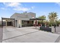 Striking modern home with a clean design, spacious driveway, and inviting outdoor entertaining area at 1211 E Hayward Ave, Phoenix, AZ 85020