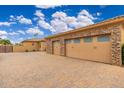 Spacious three car garage with brick paver driveway and desert landscaping provides ample parking at 13206 N 64Th St, Scottsdale, AZ 85254