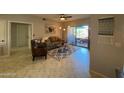 Cozy living room with a ceiling fan, tile floors, and a door to the balcony at 14950 W Mountain View Blvd # 2210, Surprise, AZ 85374