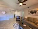 Comfortable living room with neutral tones, stylish decor, tile floors and ample seating at 14950 W Mountain View Blvd # 2210, Surprise, AZ 85374