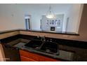 Kitchen sink with stone countertops with open view to the living room and fireplace at 16 W Encanto Blvd # 305, Phoenix, AZ 85003