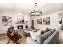 Inviting living room with a tiled fireplace, comfortable seating, and hardwood floors at 16227 N 63Rd Pl, Scottsdale, AZ 85254