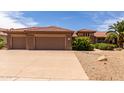 Spacious three-car garage with an extended driveway at 17406 N Escalante Ln, Surprise, AZ 85374
