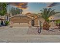 Charming single-story home with stucco facade, tile roof, desert landscaping, and attached two-car garage at 1882 W Wildhorse Dr, Chandler, AZ 85286