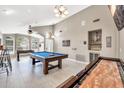 Large game room features high ceilings, a pool table, shuffleboard, and a built-in bar area at 1882 W Wildhorse Dr, Chandler, AZ 85286