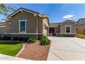 Well-maintained home with lush landscaping and a cozy, inviting entrance at 21031 E Poco Calle St, Queen Creek, AZ 85142