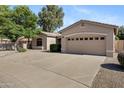 Attractive exterior of a single-story home featuring a well-maintained yard and a spacious two-car garage at 21299 E Roundup Way, Queen Creek, AZ 85142