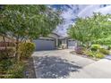 Beautiful home with a long driveway, a two-car garage, and professional landscaping at 21711 E Arroyo Verde Dr, Queen Creek, AZ 85142