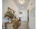 Elegant foyer with a decorative mirror, chandelier, and neutral tile flooring at 21711 E Arroyo Verde Dr, Queen Creek, AZ 85142