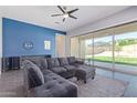 Cozy living room featuring a sectional sofa, large sliding glass doors, and stylish tile floors at 2365 N Springfield St, Buckeye, AZ 85396