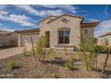 Charming one-story home with a quaint front yard and neutral stucco exterior under a sunny sky at 262 S 164Th Dr, Goodyear, AZ 85338