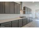 Modern kitchen featuring stylish gray cabinets, sleek stainless steel appliances, and bright white subway tile backsplash at 262 S 164Th Dr, Goodyear, AZ 85338