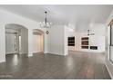 Spacious living room featuring a fireplace, modern lighting fixtures and tile floors at 26264 N 46Th St, Phoenix, AZ 85050