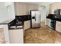 Kitchen featuring stainless steel appliances, granite countertops, tile flooring, and white cabinets at 3502 W Belle Ave, San Tan Valley, AZ 85144