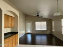 Open-concept living room featuring wood cabinets, dark wood floors, and natural light at 3633 E Potter Dr, Phoenix, AZ 85050