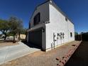 Two-story home featuring an attached two-car garage and a well-maintained front yard at 37061 W Bello Ln, Maricopa, AZ 85138
