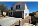 Two-story home featuring an attached two-car garage and a well-maintained front yard at 37061 W Bello Ln, Maricopa, AZ 85138