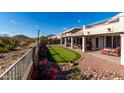 Expansive backyard boasts a putting green, covered patio, and mountain views for luxurious outdoor living at 4304 N Ranier --, Mesa, AZ 85215